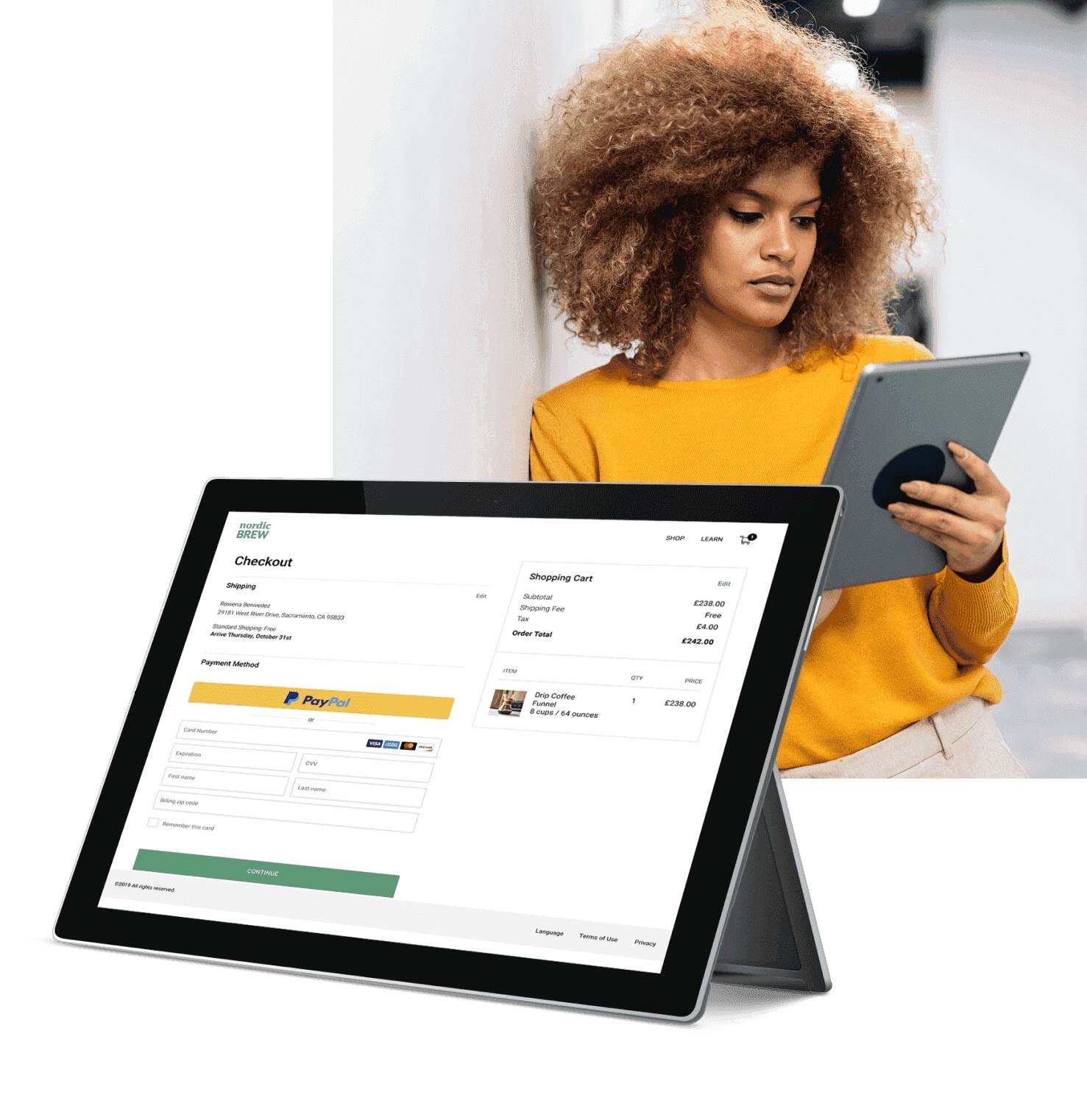 A woman is using her tablet to make a purchase online with PayPal