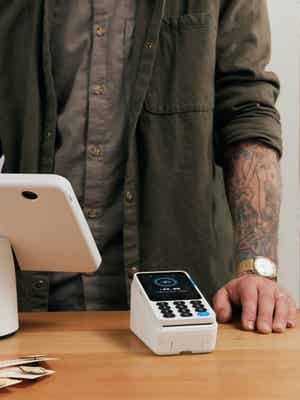 Merchant preparing for an in-person transaction with the sleek, fast, and easy to use PayPal POS system