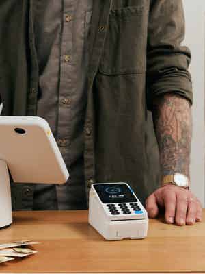 Image of a merchant setting up a purchase in person with the sleek, fast, and easy-to-use PayPal POS system